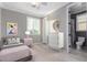 Staged bedroom featuring neutral walls, light flooring, and ensuite bathroom at 20576 W Briarwood Dr, Buckeye, AZ 85396