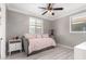 Bedroom featuring neutral walls, updated ceiling fan and light, and gray daybed at 20576 W Briarwood Dr, Buckeye, AZ 85396