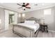 A bedroom that has laminated floors, ceiling fan and decorative bed at 20576 W Briarwood Dr, Buckeye, AZ 85396