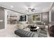 Open concept living room showcases stylish decor, plenty of natural light, and luxury flooring at 20576 W Briarwood Dr, Buckeye, AZ 85396