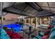 Comfortable patio seating area with a pool view under a shaded structure, perfect for outdoor relaxation and enjoyment at 20576 W Briarwood Dr, Buckeye, AZ 85396