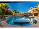 Backyard featuring a swimming pool, water features, and lush landscaping for privacy and beauty at 20576 W Briarwood Dr, Buckeye, AZ 85396