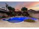 Backyard pool with lush landscaping, a gazebo, and water features, perfect for evening relaxation at 20576 W Briarwood Dr, Buckeye, AZ 85396