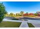 A neighborhood street view highlighting manicured landscaping and sidewalks in front of single Gathering homes at 20576 W Briarwood Dr, Buckeye, AZ 85396