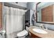 Bathroom featuring a shower-tub combo with granite topped vanity and storage cabinet at 2110 W Morrow Dr, Phoenix, AZ 85027