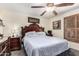 Comfortable bedroom featuring a ceiling fan and detailed wood headboard at 2110 W Morrow Dr, Phoenix, AZ 85027