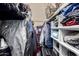 Organized walk-in closet with clothing and storage containers at 2110 W Morrow Dr, Phoenix, AZ 85027