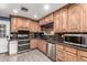 Well-lit kitchen featuring stainless steel appliances and maple cabinets at 2110 W Morrow Dr, Phoenix, AZ 85027