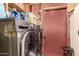 Laundry room with washer and dryer hookups and a red door at 2110 W Morrow Dr, Phoenix, AZ 85027