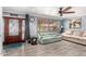 Inviting living room with wood-look floors, plenty of natural light, and ceiling fan at 2110 W Morrow Dr, Phoenix, AZ 85027