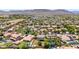 Scenic aerial view of a desert community featuring well-maintained homes, mature trees, and mountain views at 2116 W Fawn Dr, Phoenix, AZ 85041