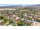 Aerial view of neighborhood featuring lush landscaping, mature trees, swimming pools, and mountain views at 2116 W Fawn Dr, Phoenix, AZ 85041