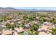 Scenic aerial view of a desert community featuring well-maintained homes, private pools, and mountain views at 2116 W Fawn Dr, Phoenix, AZ 85041