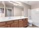 Bathroom featuring a double sink vanity and a shower over tub at 2116 W Fawn Dr, Phoenix, AZ 85041