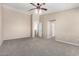 Large bedroom features a ceiling fan and neutral carpet at 2116 W Fawn Dr, Phoenix, AZ 85041
