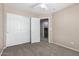 Bedroom boasts neutral carpet and paint, two closets and one additional door at 2116 W Fawn Dr, Phoenix, AZ 85041