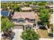 Two-story home featuring a tile roof, neutral color palette, manicured landscaping, and an attached two-car garage at 2116 W Fawn Dr, Phoenix, AZ 85041