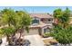A stunning two-story home showing off the home's unique architectural features, attached garage, and front yard landscaping at 2116 W Fawn Dr, Phoenix, AZ 85041