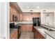 Traditional kitchen with wood cabinets, granite countertops, and tile flooring at 2116 W Fawn Dr, Phoenix, AZ 85041