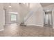 A spacious living room with soaring ceilings, a staircase, tile floors, and a view into an adjacent room with a window at 2116 W Fawn Dr, Phoenix, AZ 85041
