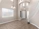 A large, open living room with high ceilings, a grand staircase, decorative lighting, and natural light streaming in at 2116 W Fawn Dr, Phoenix, AZ 85041
