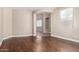 An open-concept living space with hardwood floors, an arched entryway, a window for natural light, and neutral wall color at 2116 W Fawn Dr, Phoenix, AZ 85041