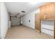 Spacious garage with storage cabinets and a roll-up door at 230 E Fairmont Dr, Tempe, AZ 85282
