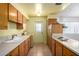 Galley kitchen featuring wooden cabinetry and essential appliances at 230 E Fairmont Dr, Tempe, AZ 85282