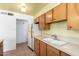 Kitchen featuring light wood cabinets, tiled floor, stainless steel sink, and a white refrigerator at 230 E Fairmont Dr, Tempe, AZ 85282