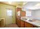 A classic kitchen features wood cabinets, tiled floors and an exterior door at 230 E Fairmont Dr, Tempe, AZ 85282