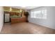 Open-concept living room featuring a kitchen bar and lots of light from the large window at 230 E Fairmont Dr, Tempe, AZ 85282