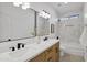 Modern bathroom featuring double sinks, wood cabinetry, and decorative tile at 2774 E Valencia St, Gilbert, AZ 85296