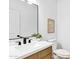 Modern bathroom featuring a floating vanity with black faucet and a large rectangular mirror at 2774 E Valencia St, Gilbert, AZ 85296