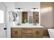 Modern bathroom featuring double sinks, wood cabinetry, and decorative tile at 2774 E Valencia St, Gilbert, AZ 85296