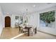 Bright dining area featuring a chandelier, a wood table, and multiple windows with outdoor views at 2774 E Valencia St, Gilbert, AZ 85296