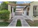 Exterior shot showcasing a long driveway with a pergola leading to a detached garage at 2774 E Valencia St, Gilbert, AZ 85296