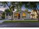 Charming home with lush trees, manicured lawn, and stucco exterior at dusk at 2774 E Valencia St, Gilbert, AZ 85296