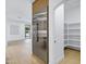 Close-up of a stainless steel refrigerator with pantry shelves visible through an open door at 2774 E Valencia St, Gilbert, AZ 85296