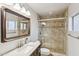 Beautiful bathroom with stone tile shower, upgraded fixtures, and an elegant framed mirror at 2847 S Bala Dr, Tempe, AZ 85282