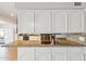 Modern kitchen featuring granite countertops, stainless steel appliances, white cabinetry, and a seamless transition to the living area at 2847 S Bala Dr, Tempe, AZ 85282