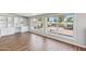 Sunlit room with laminate floors, built-in shelving, and views of an outdoor patio featuring a fire pit and lush backyard at 2847 S Bala Dr, Tempe, AZ 85282