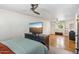 Spacious bedroom with a ceiling fan, laminate floors, a large window, and a TV on a stand at 2847 S Bala Dr, Tempe, AZ 85282