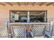 View of a patio bar with a countertop, bamboo siding, decorated tiki posts, and bar seating overlooking the garage at 2847 S Bala Dr, Tempe, AZ 85282