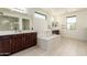 Bathroom featuring dual vanities, soaking tub, and separate glass shower at 2920 E Virginia E St, Mesa, AZ 85213