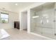 Bright bathroom with a glass shower enclosure, tile floors, and a view to the outside at 2920 E Virginia E St, Mesa, AZ 85213