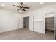Bedroom with carpeted floors, ceiling fan, closet, and an attached room at 2920 E Virginia E St, Mesa, AZ 85213