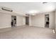 Spacious living room featuring neutral paint, carpet flooring, and modern lighting fixtures at 2920 E Virginia E St, Mesa, AZ 85213