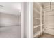Walk-in pantry featuring adjustable shelving, tile floors, and a view into a carpeted room at 2920 E Virginia E St, Mesa, AZ 85213
