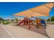 Neighborhood playground under a shade structure with a slide and play equipment at 2920 E Virginia E St, Mesa, AZ 85213