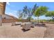 Backyard patio features a dining table with comfortable seating, beautiful landscaping, and privacy wall at 29368 N Red Finch Dr, San Tan Valley, AZ 85143